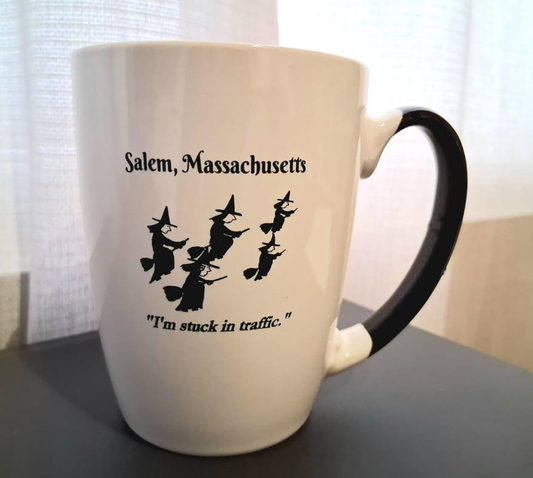 "I'm stuck in traffic." White, ceramic, 12oz coffee mug with black handle and interior.