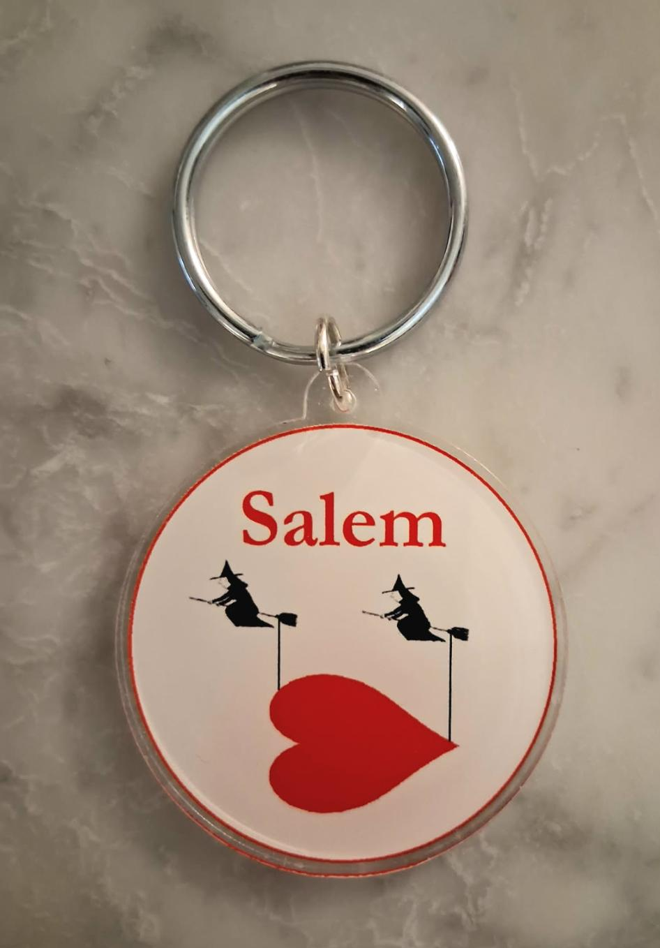 Two witches flying a heart over Salem. Key chain