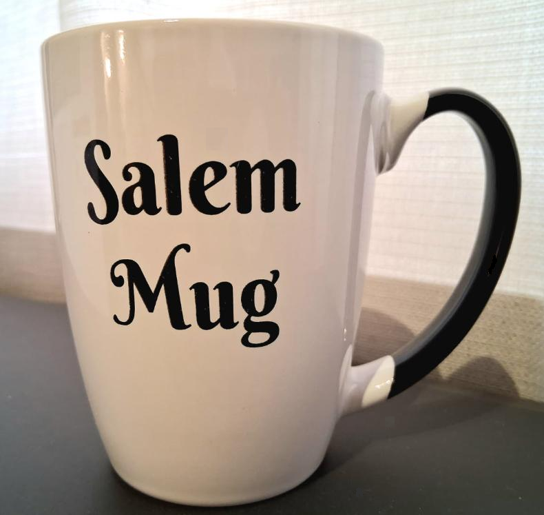 "Salem Mug" "Salem Mug Shot" White, ceramic, 12oz, two-sided coffee mug with black handle and interior.